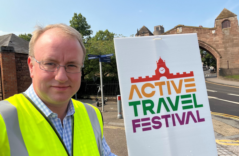 Simon Eardley in hi viz vest with Active Travel Festival sign next to him