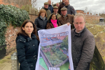 Simon Eardley holding up a banner with other people on Chester's city walls